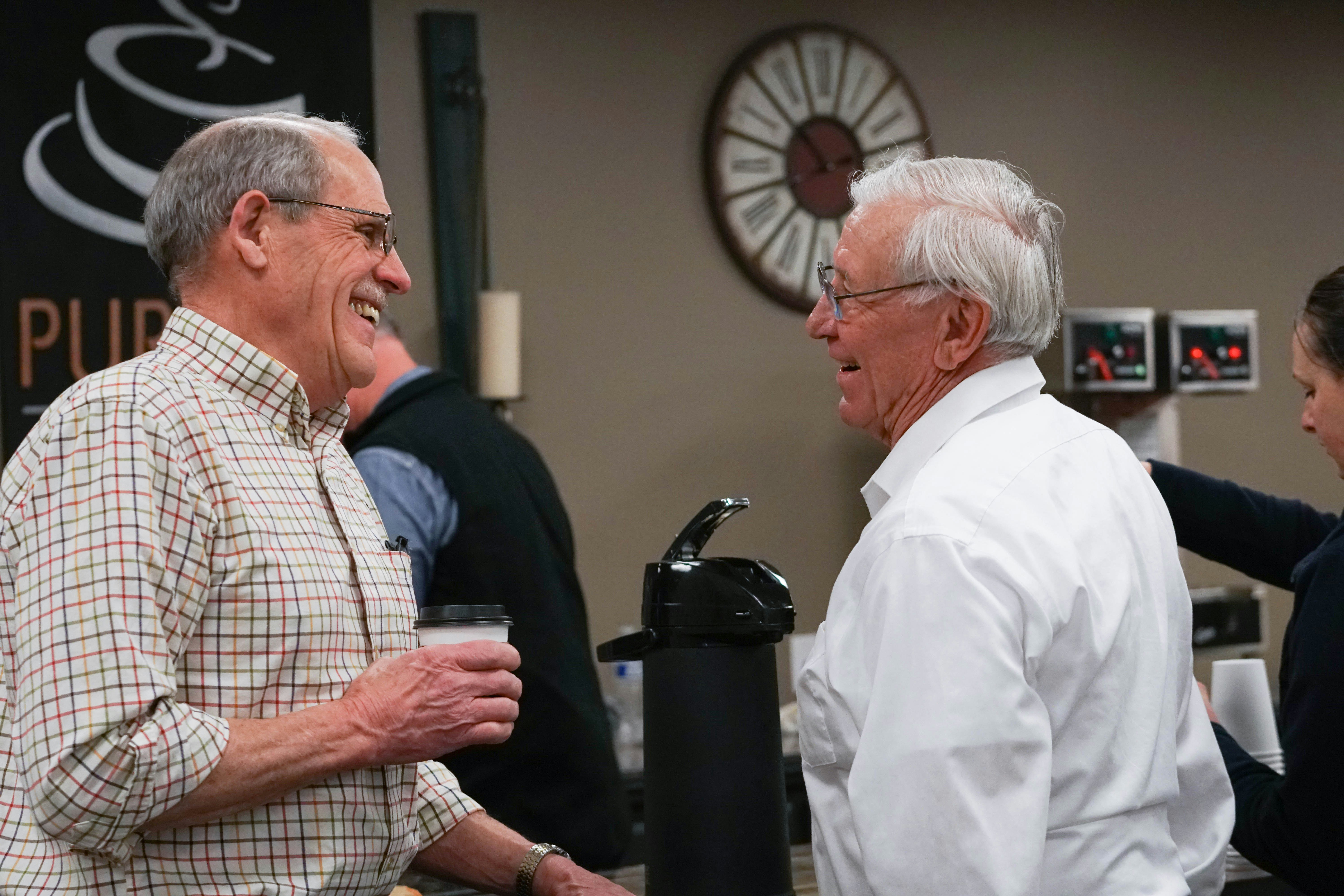 Church volunteer welcoming people through open doors